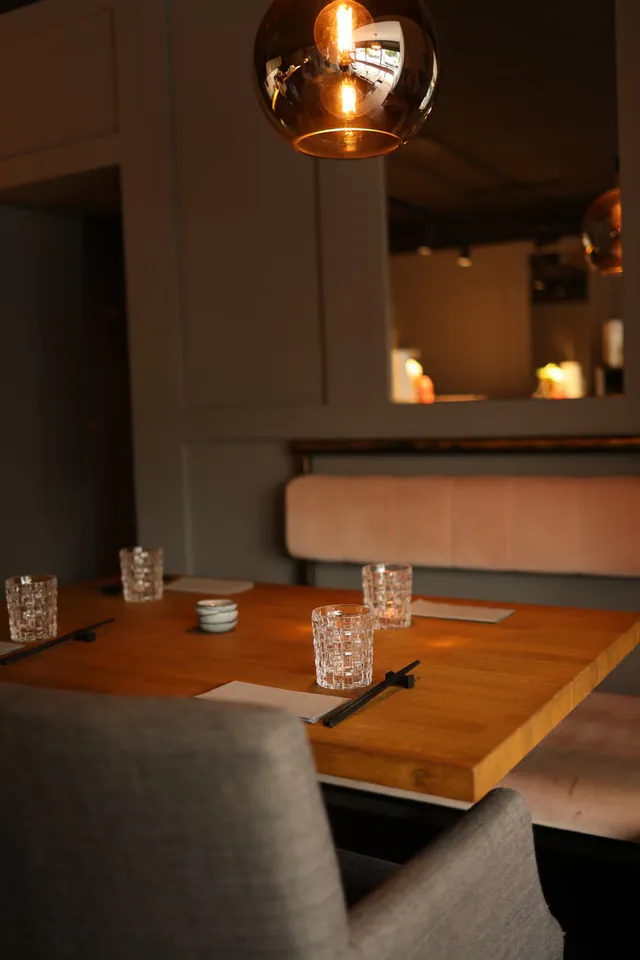 A warm restaurant interior with a set table.